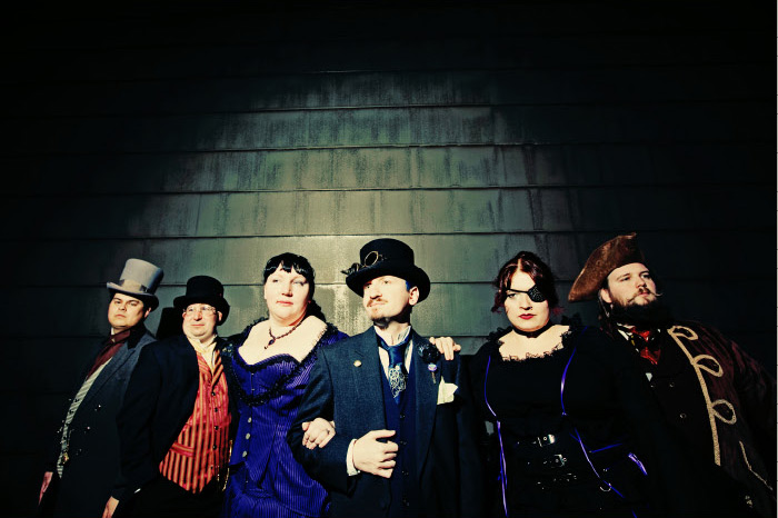 fun and colorful photo of the bridal party at a steampunk wedding
