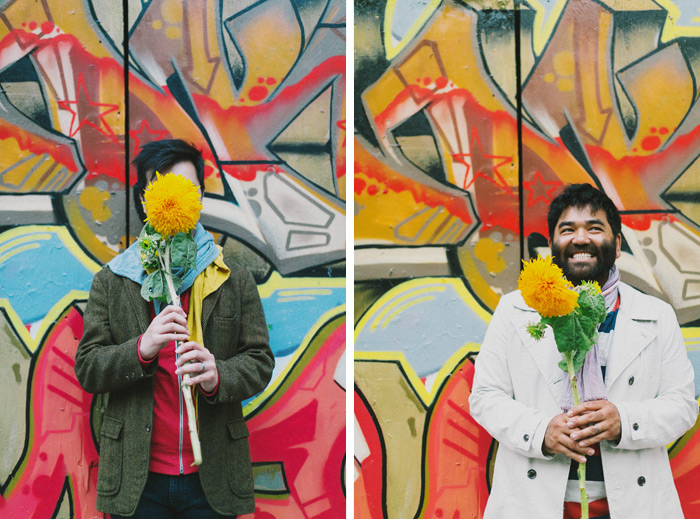cute gay couple holding flowers during engagement session