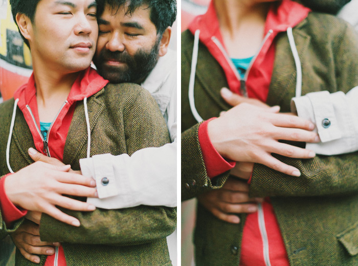 sweet gay couple hugs in engagement photo in san francisco