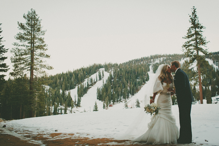 Bride and Groom kiss in snowy winter setting