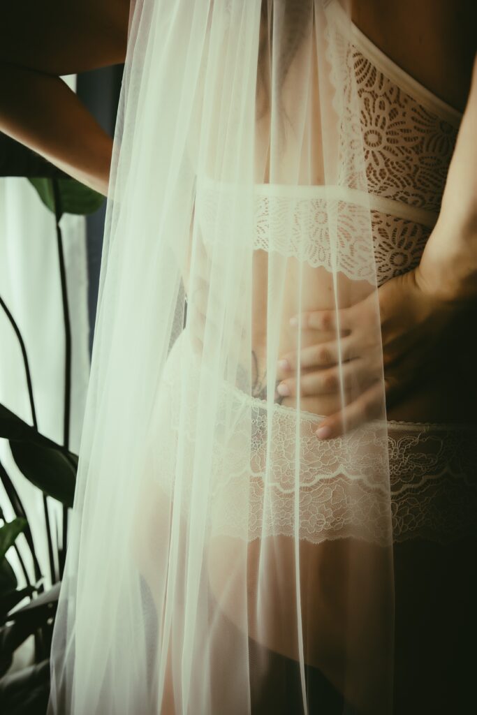 woman in white lingerie, wearing wedding veil in sacramento bridal boudoir session 