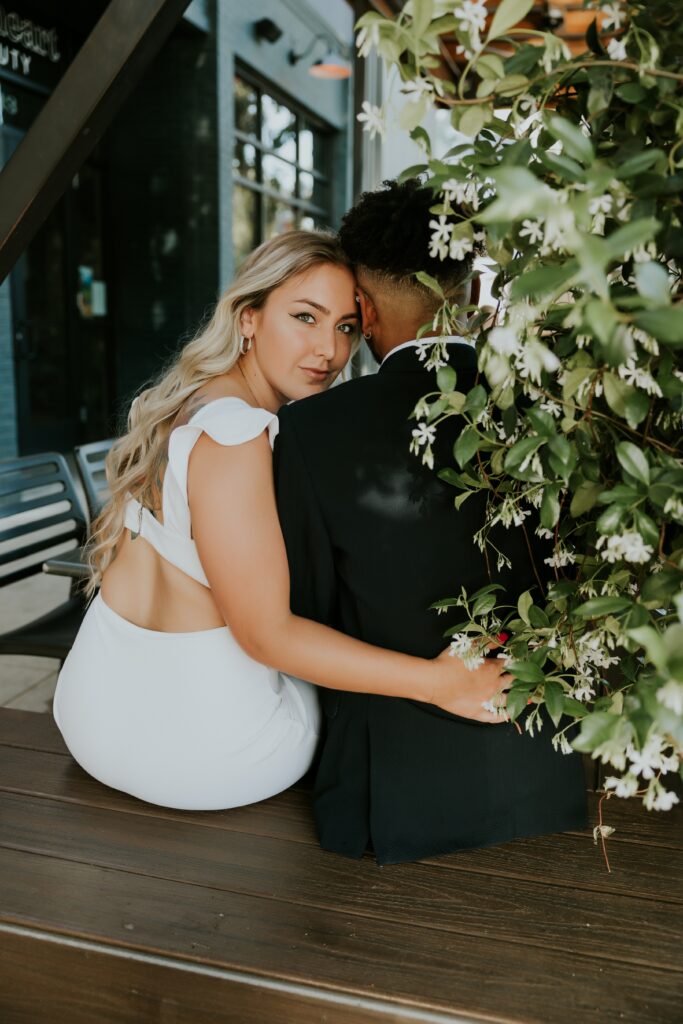 Sacramento engagement session with woman in all white with blonde hair and green eyes, with man in black suit