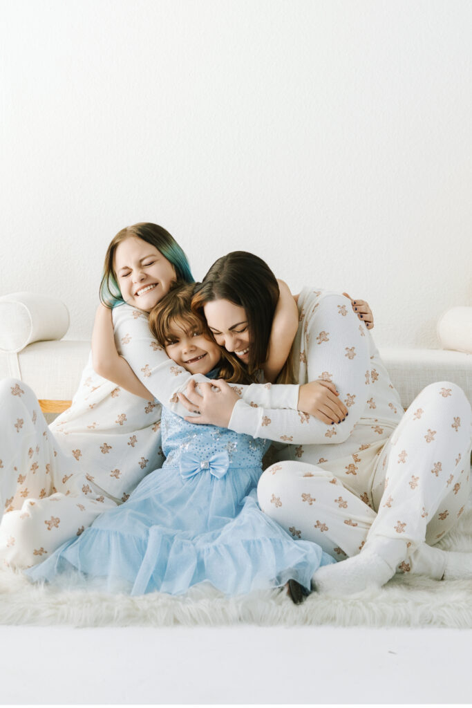 Minimalist family portrait photographed in a modern studio setting