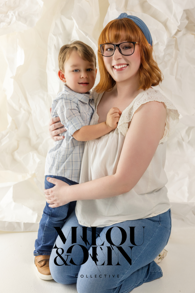 Mother and toddler portrait featuring a smiling red-haired mother holding her young son during a warm and joyful Sacramento family photo session.