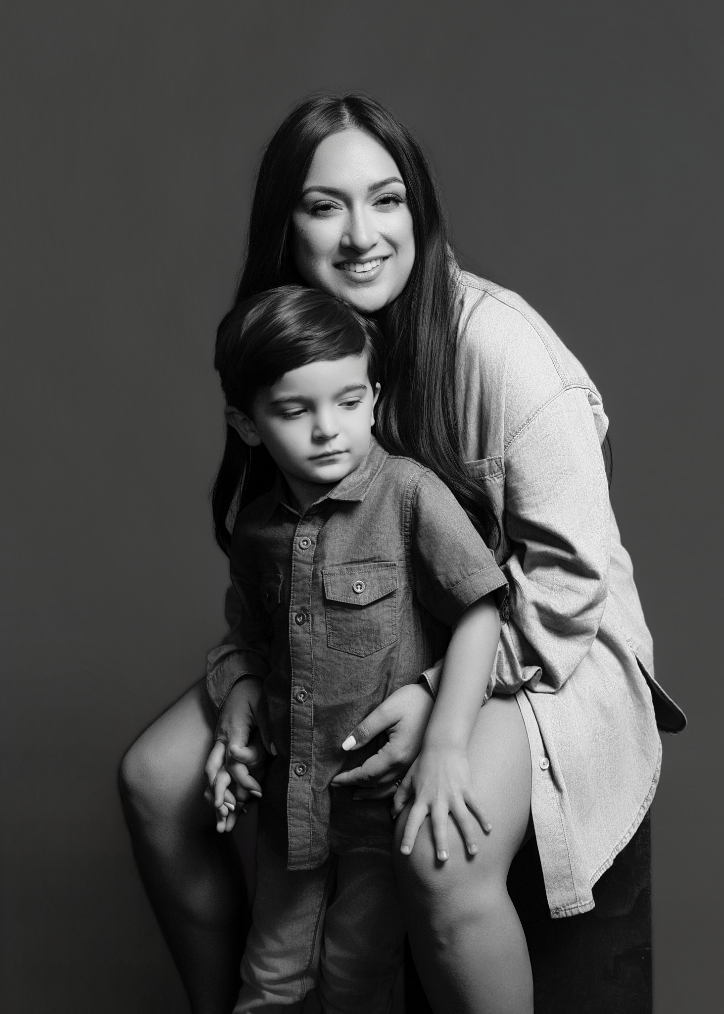 Motherhood photography at a Sacramento studio — a mother in a relaxed, connected moment with her children